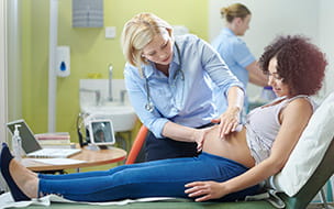 A midwife assists a patient