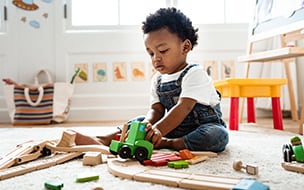 Cute little boy playing with a toy train