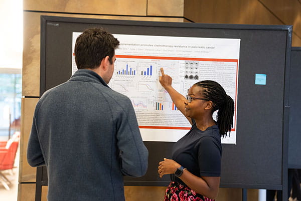 Faith Nakazzi presents her research during poster exhibit.