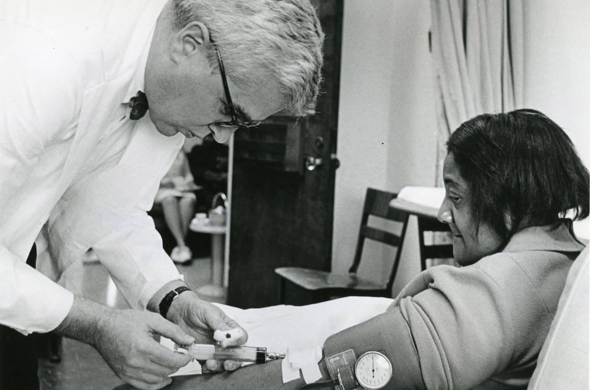 physician administers orinase test to diabetes patient in the 1960s
