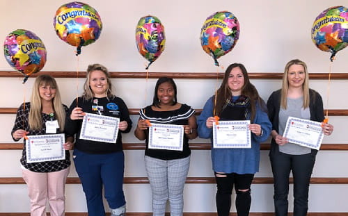 Sarah Blair, Alicia Nation, Shyvonne Rusher, Olivia Sott and Lauren Lewis show their scholarship certificates