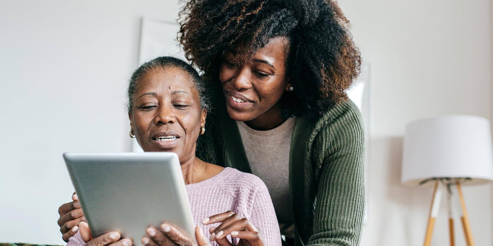 therapist assisting elderly woman