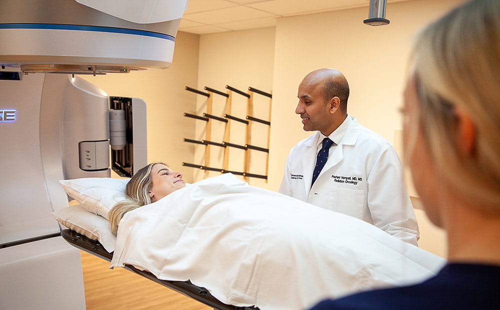 Prashant Vempati, MD MS observes a patient being treated with the Varian Edge radiosurgery system