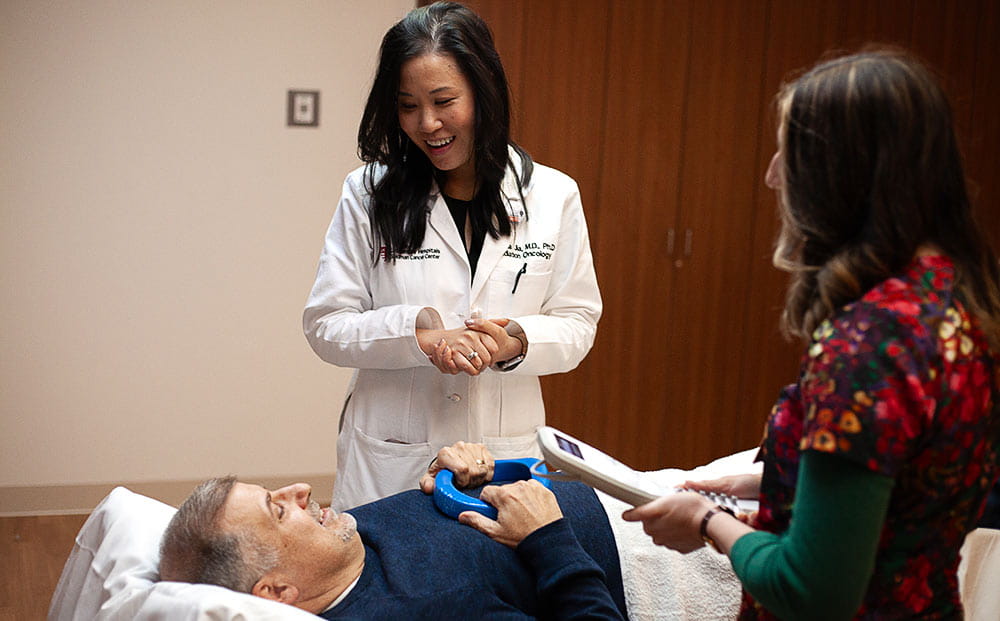 Radiation Therapist Elise DeMartino treats a male patient