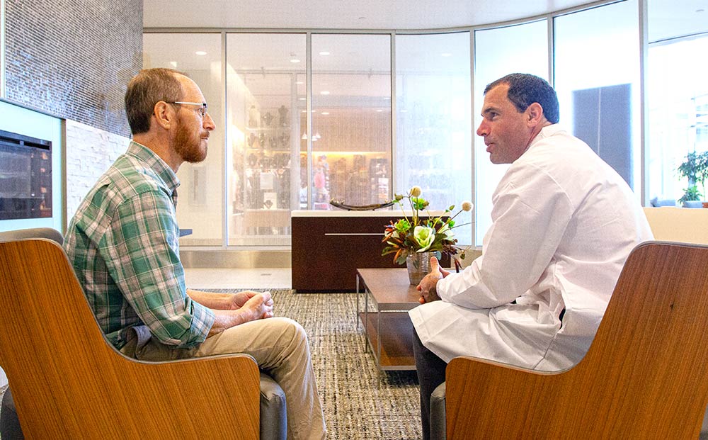 Jordan Winter, MD in conversation with a patient